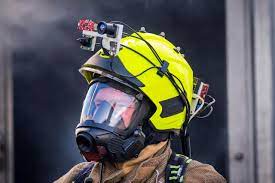 Firefighter wearing a helmet with sensors located on the top center.