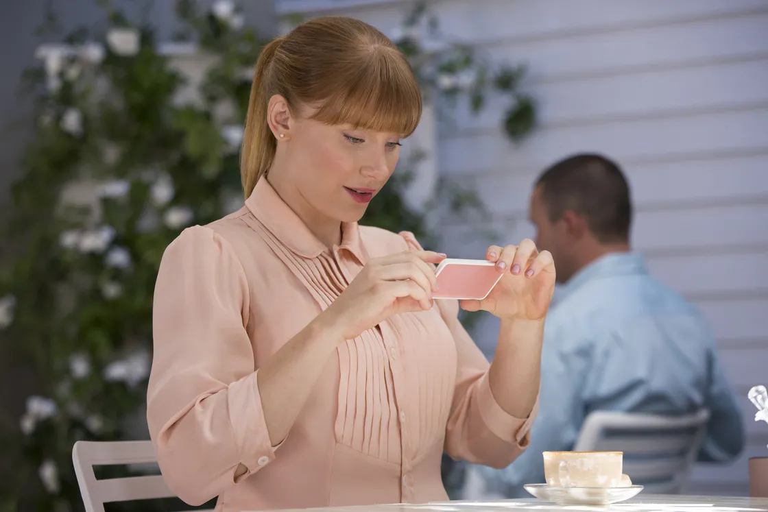 Image of woman taking a picture of her food, from show Black Mirror.